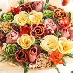 a platter filled with lots of different types of food on top of a table