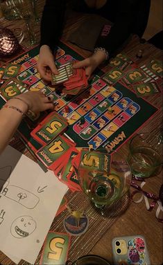 two people sitting at a table playing games