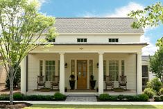 the front view of a white house with columns