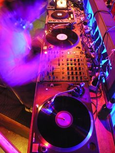 two turntables are sitting next to each other in front of a dj's mixer