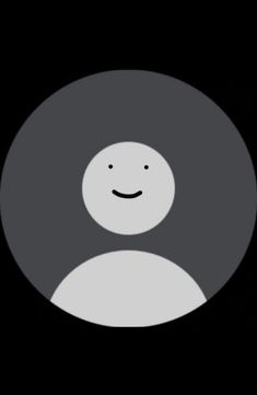 a black and white circle with a smiley face on it's center, in front of a dark background