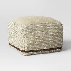 a white and brown poufce sitting on top of a table