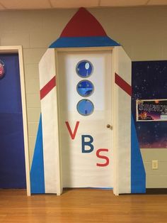 a door with the word v8bs painted on it in front of a rocket ship