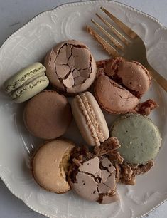 a white plate topped with different types of macaroons