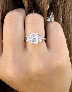 a woman's hand with a diamond ring on it