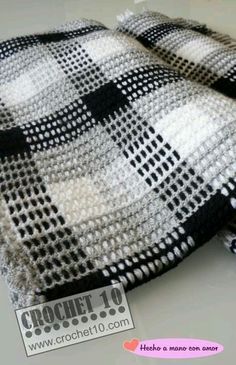 a black and white checkered blanket sitting on top of a table