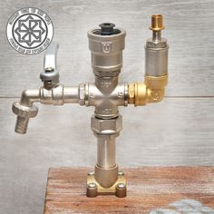 an old style water faucet on a wooden table