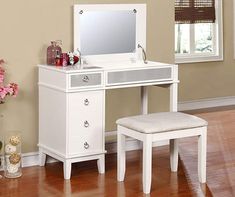 a white dressing table with stool and mirror