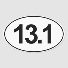 a white and black oval sticker with the number thirteen on it's side