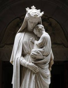 a statue of the virgin mary holding a child