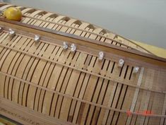 a close up of a boat made out of wooden planks with metal hooks on it