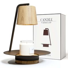 a table lamp next to a box with a candle on it and a wooden base