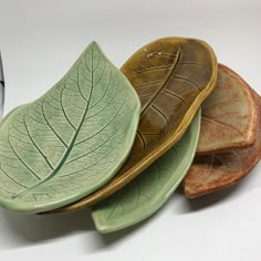 three leaf shaped plates sitting on top of each other