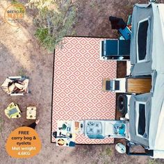 an overhead view of a table and chairs on the ground with a cover over it