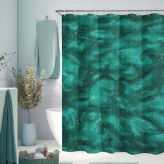 a bathroom with a green shower curtain in it