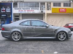 a silver car parked in front of a building