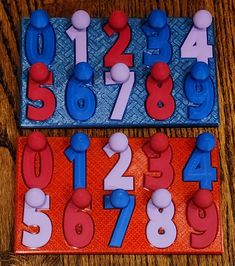 two plastic numbers and one number are on the table with red, white, and blue magnets