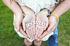 two people holding their hands together with the word forever spelled in scrabble letters