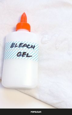 a bottle of bleach gel sitting on top of a bed