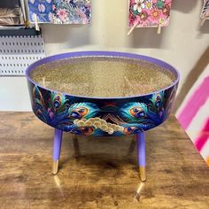 a table that has some kind of colorful bowl on it with gold glitter in the middle