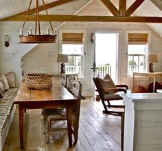 a living room filled with furniture and a wooden table