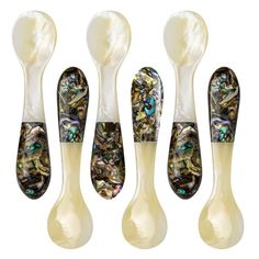 four spoons with different designs on them