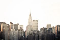 a city skyline with tall buildings in the foreground and skyscrapers in the background