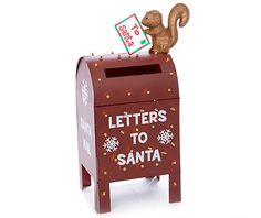 a wooden toy mailbox with a squirrel on top and letters to santa written on it