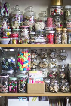 a shelf filled with lots of different types of candy and candies on top of it