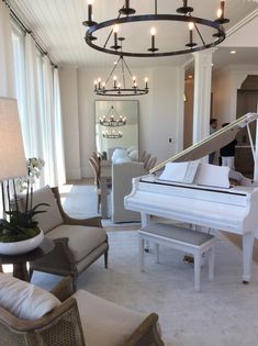 a living room filled with furniture and a grand piano