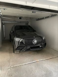 a black car is parked in the garage