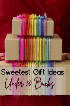 a stack of wrapped gift boxes with the words sweetest gift ideas under 30 bucks