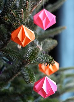 three origami ornaments hanging from a tree