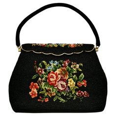 Beautiful black beaded handbag featuring floral tapestry embroidery, and gold plated fittings. Measuring length at the base 22 cm / 8.6 inches by width 10 cm / 3.9 inches, and depth 4 cm / 1.5 inches. The handle drop is 13 cm / 5.1 inches. The bag closes with a scalloped edged hinged closure. Inside there is a black satin lining with a pocket. The bag is in very good condition. There are three loose beads, and possibly a very few missing beads. This is a really lovely bag circa 1950s. Made in Ho Chic Evening Bags, Vintage Clutch Purse, Vintage Evening Bags, Embroidered Handbag, Satin Noir, Suede Clutch, Beaded Evening Bags, Vintage Clutch, Beaded Bag