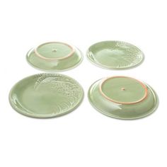 four green plates sitting on top of each other