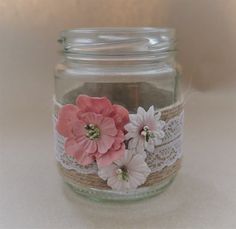 a glass jar filled with pink and white flowers