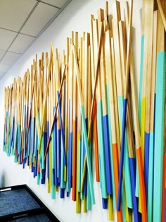 an office wall with many different colored sticks on it