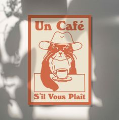 a sign that says un cafe si vous plat with a cat wearing a hat