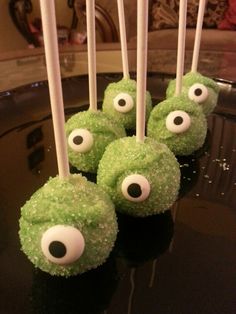 some green cake pops with googly eyes on them