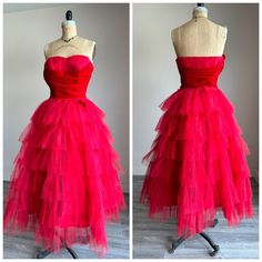 Slightly wounded Ravishing red 1950's prom dress Absolutely beautiful!! The bodice is strapless with gathers of red tulle and soft red velvet! The skirt of the dress has rows and tiers of radiant red tulle with little red velvet bows on every other or about row of the tulle. The dress is lined in taffeta with a boned bodice and side metal zipper for closure. The condition is slightly wounded. The velvet on the bodice needs a stitch or two between the bust. The interior is faded and discolored. A loop needs to be replaced near the zipper and a few scattered spots. This is definitely wearable with a little TLC Approximate size: small The measurements are taken flat and doubled where needed Bust: 35 Waist: 26 Hip: free/open Bodice: 10 1/2 Waist to hem: 37 Thanks for looking and please feel fr 1950s Prom, 1950s Prom Dress, Velvet Bows, Velvet Prom Dress, Radiant Red, Boned Bodice, Soft Red, Velvet Bow, Huntington Beach