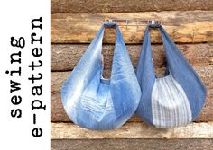 two denim bags hanging on a wooden wall