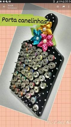 an image of a cell phone case with buttons and bows on the front, attached to a clipboard