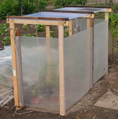 a large metal container sitting in the middle of a garden