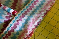 a piece of fabric sitting on top of a cutting board