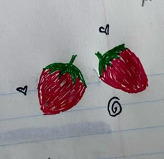 a drawing of two strawberries on lined paper