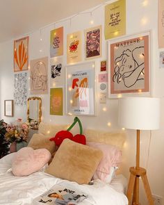 a bedroom with posters and lights on the wall