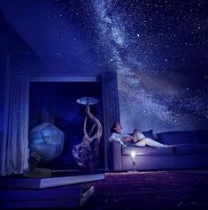 a person laying on a couch under the stars