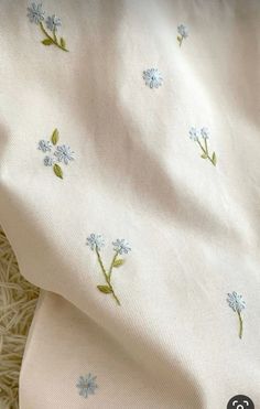 a white sheet with blue flowers on it