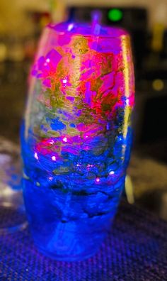 a colorful vase sitting on top of a table