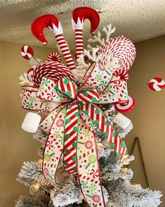 a christmas tree decorated with candy canes and bows